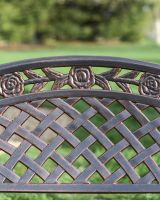 Roses on copper bench close up 