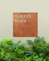 Rustic Steel Square House Name Sign Mounted onto a Painted House Wall