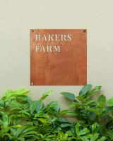 Rustic Steel Square House Name Sign Mounted onto a Painted House Wall Rustic Steel Square House Name Sign Mounted onto a Painted House Wall