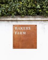 Corten Steel Square House Name Sign on a White Garden Wall