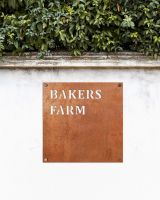 Corten Steel Square House Name Sign on a White Garden Wall Corten Steel Square House Name Sign on a White Garden Wall