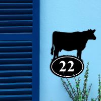 Cow Iron House Number Sign on a Blue Wall