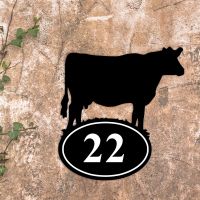 Cow Iron House Number Sign in Situ on a Rustic Wall 