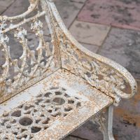 Close up of Antique Cream Cast Iron Two Seater Bench 
