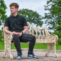 Male sat on Antique Cream Gothic Bench for Scale 