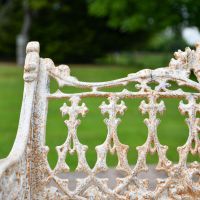 Close up of Antique Cream Cast Iron Garden Bench 