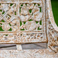 Close up of Antique Cream Cast Iron Garden Bench 