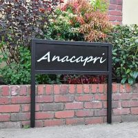 Black Iron Standing House Name Sign Next to a House Black Iron Standing House Name Sign Next to a House