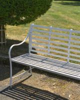 Close up of intricate detail on white garden bench Close up of intricate detail on white garden bench