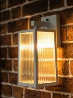 Digital representation of davenport ribbed glass white wall lantern lit up at night