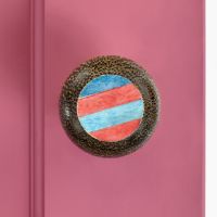 Unique Blue and red door knob on a pink door