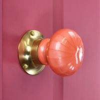 "Sunrise Orange" Hand Finished Ceramic Door Knob on a Pink Door "Sunrise Orange" Hand Finished Ceramic Door Knob on a Pink Door