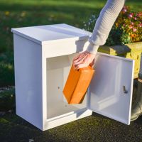 Lockable Front in Use on Deluxe White "Bexley" Free Standing Parcel Box Lockable Front in Use on Deluxe White "Bexley" Free Standing Parcel Box