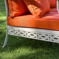 Close-Up of White Aluminium Frame with Orange Cushions
