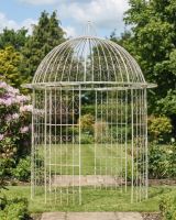 Deluxe Wrought Iron "Alaina" Champagne Powder Coated Gazebo ai illustration in a lush garden