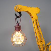Close-up of the Crane Design Golding the Light Bulb