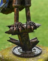 Close up of feet and base detail on recycled metal art sculpture Close up of feet and base detail on recycled metal art sculpture