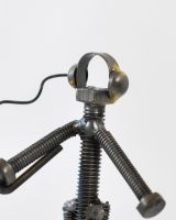 Close up of intricate person detail on recycled metal art sculpture