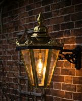 Digital Illustration of the Brass "Brampton" Hexagonal Lantern with Bracket Illuminated at Night