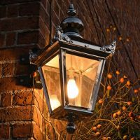 Digital Illustration of the Bright Chrome Suspended Corner Wall Lantern Illuminated at Night.