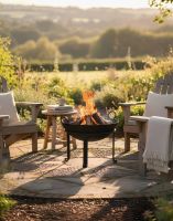 Digital Illustration of the "Agni" Iron Kadai Fire Bowl Lit in a Garden Overlooking the Countryside