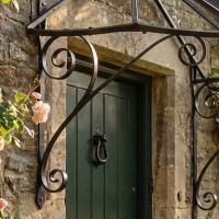 Digital illustration of "Honeysuckle Cottage" Wrought Iron Door Canopy in black close up view of supports Digital illustration of "Honeysuckle Cottage" Wrought Iron Door Canopy in black close up view of supports
