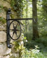 Digital illustration of "Northern Star" Hanging Basket Bracket mounted in a forest garden Digital illustration of "Northern Star" Hanging Basket Bracket mounted in a forest garden