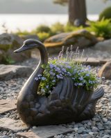 Digital illustration of Antique Bronze Swan Flower Planter placed on a rockery