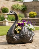 Digital illustration of Antique Bronze Swan Flower Planter positioned on a patio