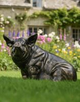 Digital illustration of an Antique Brushed Gold Sitting Pig Sculpture in garden looking at its side