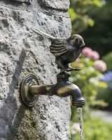 Digital illustration of Antique Finish Robin Garden Tap mounted on stone brickwork in a sunny garden scene