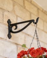 Digital illustration of Black Scroll Iron Hanging Basket Bracket on a brick wall close up image