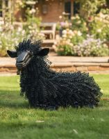 Digital Illustration of Black Sheep Bedspring Sculpture on a Shaded Garden Lawn