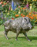 Digital illustration of a Brushed Gold Wild Boar Sculpture in a vibrant garden