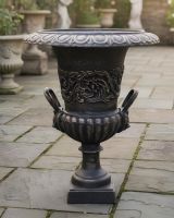 Digital illustration of Cast Iron Bronze Urn positioned in front of garden planters and sculptures