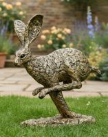 Digital illustration of "Diggory" the Sprinting Hare Garden Sculpture on a Garden Lawn with Flowers in the Background Digital illustration of "Diggory" the Sprinting Hare Garden Sculpture on a Garden Lawn with Flowers in the Background