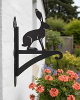Digital Illustration of the Hare Iron Hanging Basket Bracket Mounted on a White Brick Wall