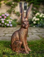Digital illustration of a bronze and copper "Hunter" the Hare Cast Aluminium Garden Sculpture in front of a garden patio