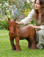 Digital illustration of Miniature Cast Iron Pony Sculpture - Rustic with lady in shot for scale