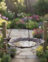 Digital Illustration of Open Leaf Hanging Bird Feeder Suspended in Front of a Garden Pathway with Colourful Flower Borders