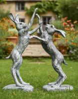 Digital illustration of Pewter Boxing Hares Sculpture on a Garden Lawn Digital illustration of Pewter Boxing Hares Sculpture on a Garden Lawn
