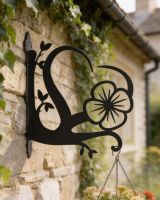 Digital illustration of Poppy Heart Hanging Basket Bracket mounted on a brick wall