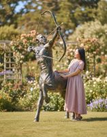 Digital illustration of Recycled Cast Aluminium Brushed Gold "Archer" Centaur Sculpture with lady stood next to sculpture for scale