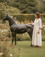 Digital illustration of Recycled Cast Aluminium Brushed Gold "Goldado" Horse Sculpture with lady in shot for scale