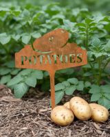 Digital illustration of Rustic "Potatoes" Vegetable Label in front of plants next to potatoes on the floor
