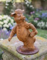 Digital illustration of Rustic Cast Iron "American Football Player" Pig Garden Sculpture positioned on a garden wall with a walled garden in the background