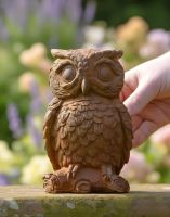 Digital illustration of Rustic Cast Iron "Horned Owl" Garden Sculpture with hand in shot for scale