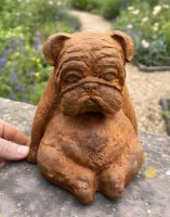 Digital illustration of Rustic Cast Iron "Bentley" the Bulldog Sculpture with hand in shot for scale