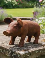 Digital illustration of a large Rustic Cast Iron Pig Sculpture positioned on a low garden wall Digital illustration of a large Rustic Cast Iron Pig Sculpture positioned on a low garden wall