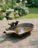 Digital Illustration of Rustic Trowel Bird Feeder on a Sunny Garden Wall